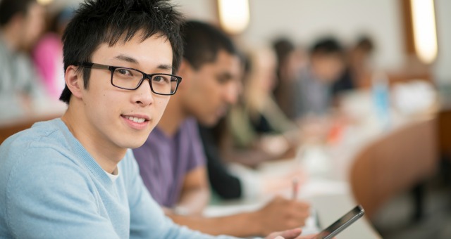 college student on smartphone in class