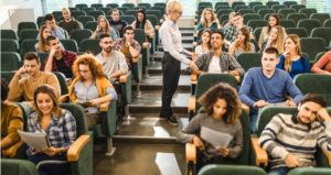 Professor has open discussion about topic in large lecture hall