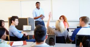 Teacher directs classroom discussion with engaged students