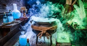 Black cauldron emits colorful smoke with potions and books surrounding it