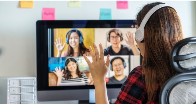 Group of students wave to one another over online discussion chat