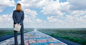 Woman stands on roadmap overlooking road