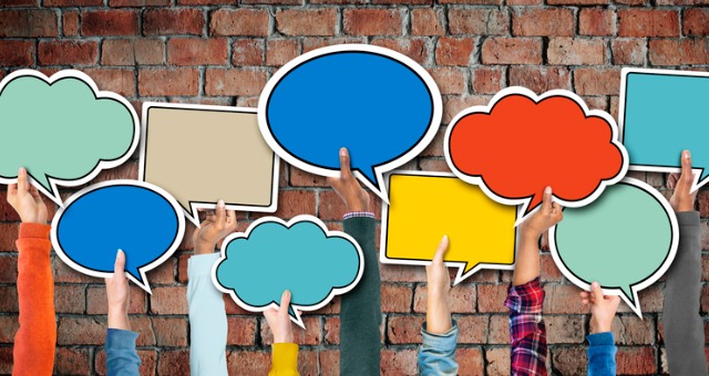 Multiethnic group holds up speech bubble signs in different colors