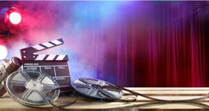 Lights, camera, action movie materials lay in front of curtain
