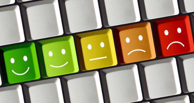 Computer keys have faces ranging from green smileys to red frown