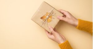 Person holds gift with leaf on it