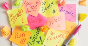 Sticky notes with words like stress, anxiety, and doubt written on it