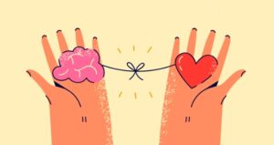 Hands holding brain and heart tied together