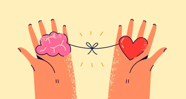 Hands holding brain and heart tied together