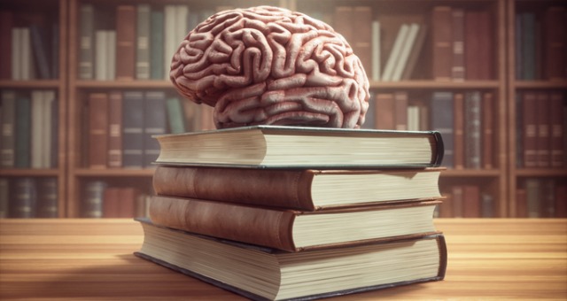Brain sitting on top of a stack of books
