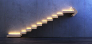 Picture of a staircase going upward and lit up with cream lighting