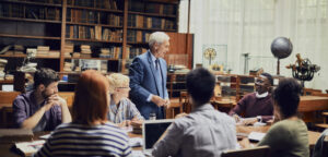 A teacher in the classroom engaging with his students.