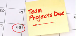 Calendar with a yellow sticky note that says Team Projects Due