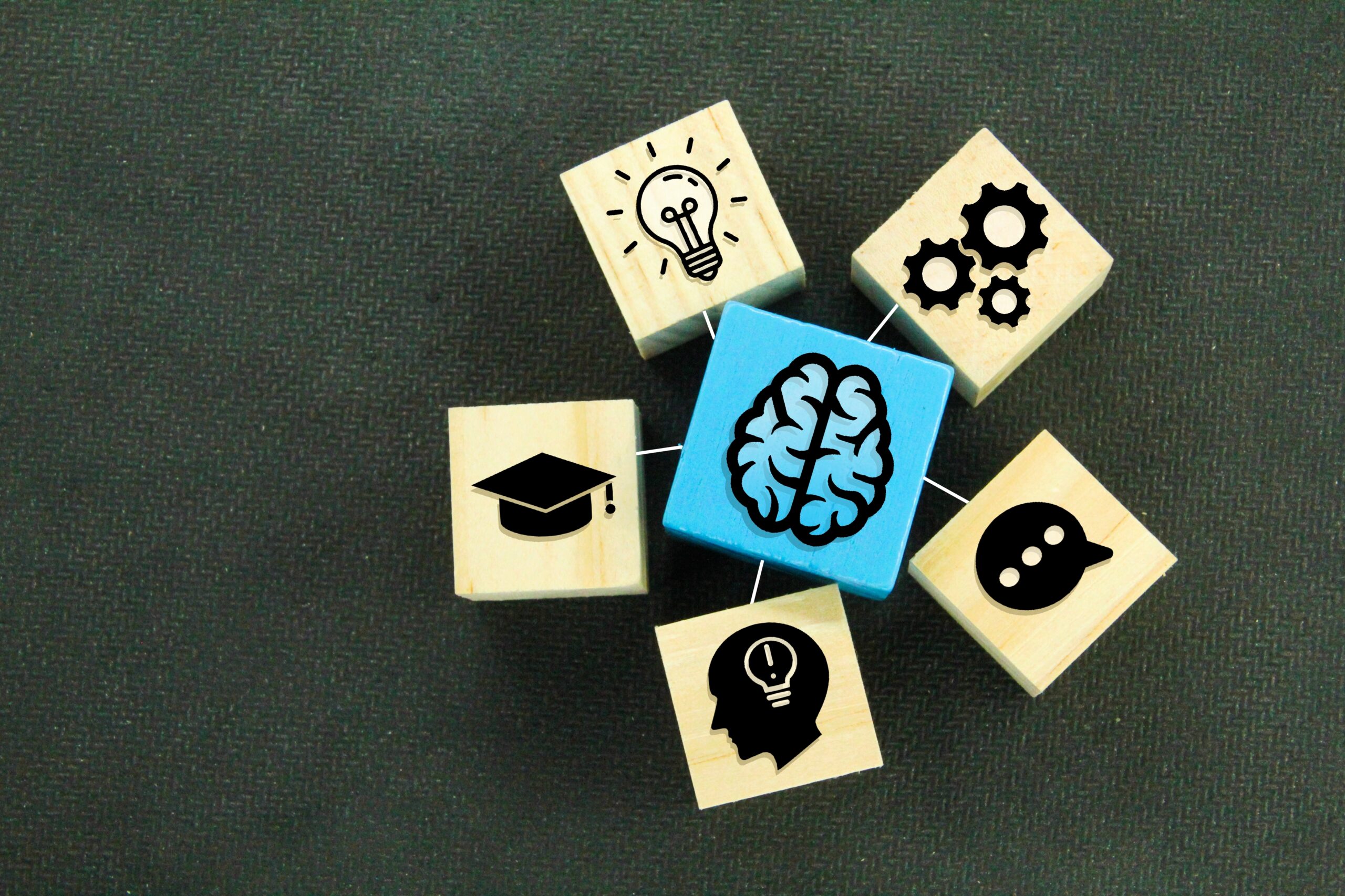 a wooden cube with an icon of an idea or a brain with its function concept