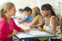 Teacher helping students with work.