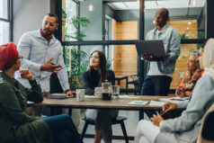 Faculty members having a group discussion during a meeting in a modern office. Team of multicultural community sharing ideas in an inclusive workplace.
