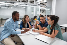 Happy group of students connecting and studying together in the classroom - education concepts