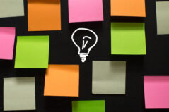 Parking Lot in Classroom. Creative ideas and a light bulb. Colorful stickers and a light bulb as a symbol of new ideas and solutions for problems.