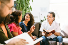 Diverse faculty at meeting discussing education.
