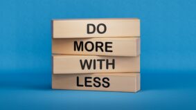 Explain it in 100 Words: Say Less, Engage More. Do more with less symbol. Concept words Do more with less on wooden blocks. Business and Do more with less concept. Copy space.3D rendering on blue background.