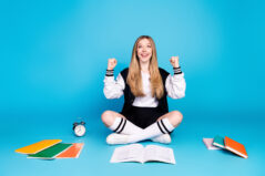 Happy, excited female college student energetic about assignment and feeling successful