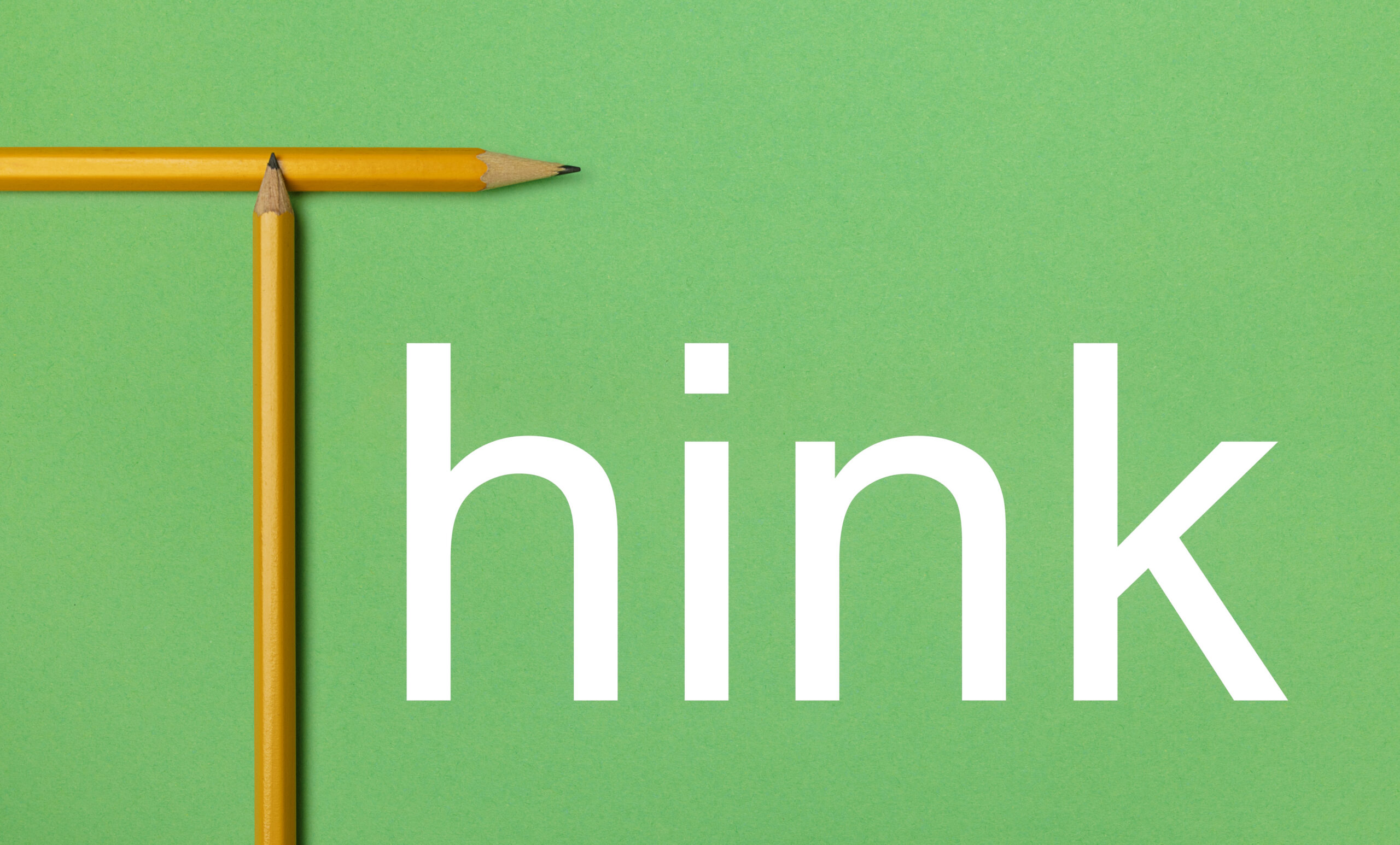 The word Think is shown using composition with a yellow pencil isolated on green paper that look minimalist with bold white text. Critical thinking while writing.