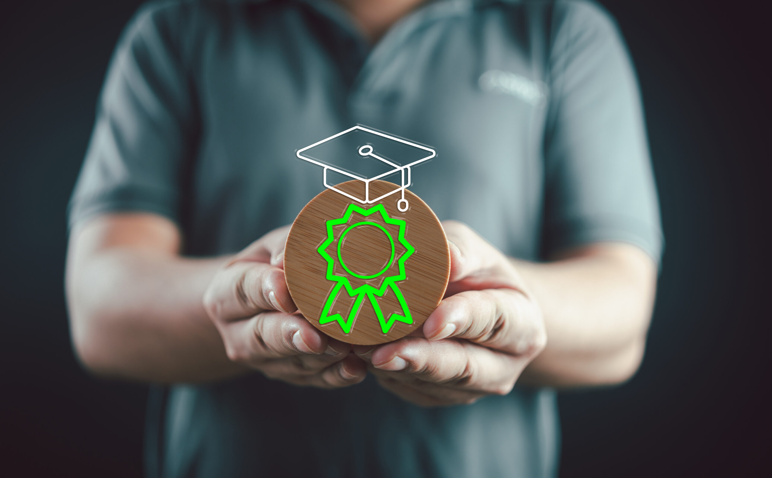 Person holding an award with a graduation cap and a ribbon symbolizing higher education instructor and teaching recognition.