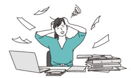 Illustration of busy and overwhelmed teacher at desk with computer and papers flying around.